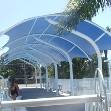 Swimming pool tensile covering